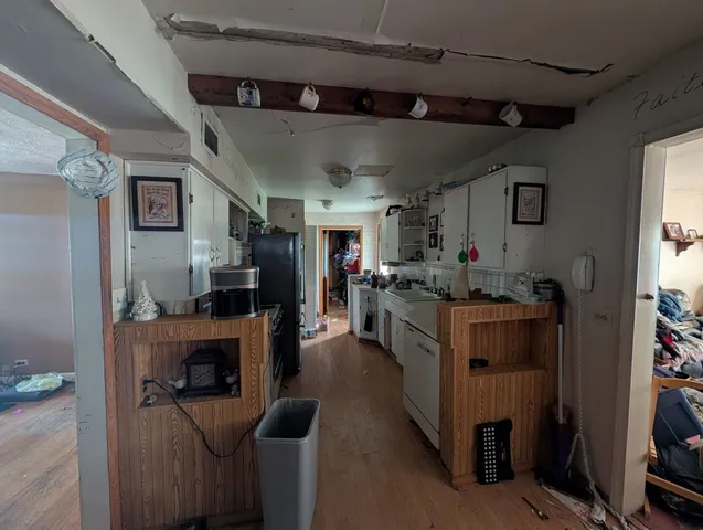 a open kitchen with cabinets a sink and a stove