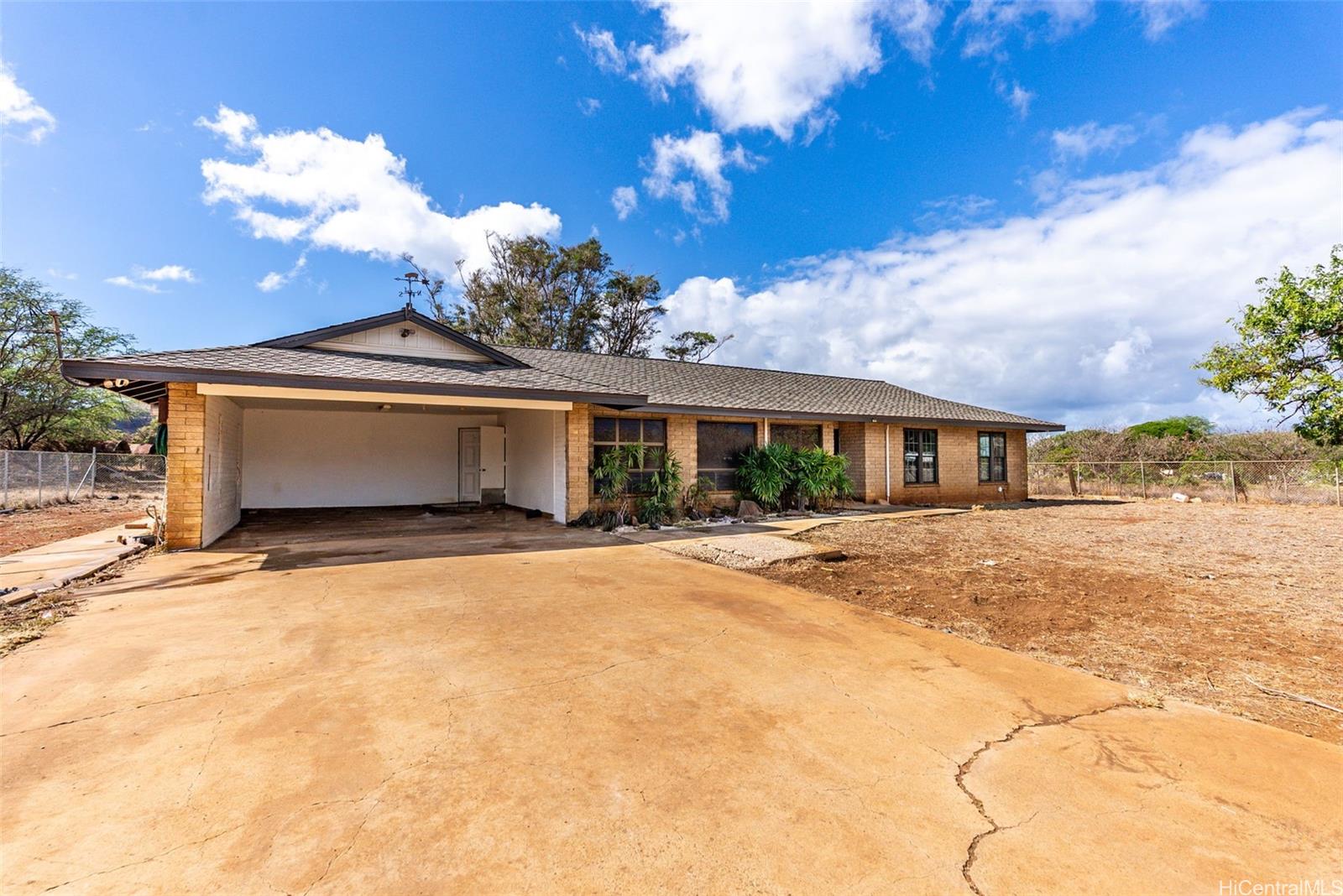 87-1087 Apuupuu Road Waianae, HI 96792 - Photo 14 of 25 a view of a house with a yard and garage