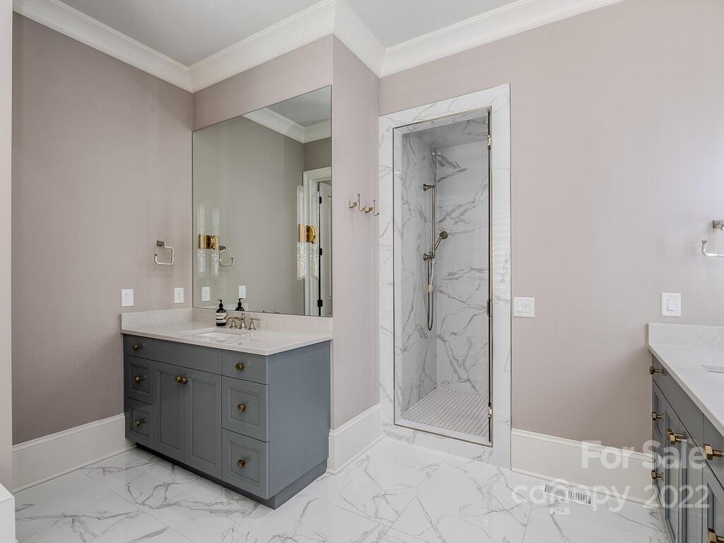 3013 Manor Road Charlotte, NC 28209 - Photo 12 of 41 a spacious bathroom with a shower a sink and a mirror