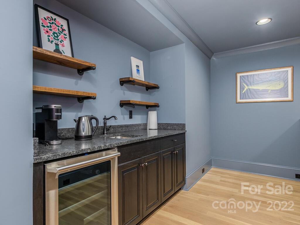 3013 Manor Road Charlotte, NC 28209 - Photo 22 of 41 a kitchen with stainless steel appliances granite countertop a sink stove and cabinets