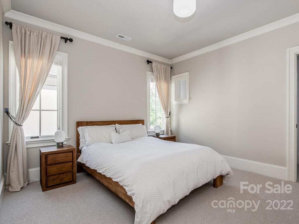 3013 Manor Road Charlotte, NC 28209 - Photo 27 of 41 a bedroom with a bed and a window