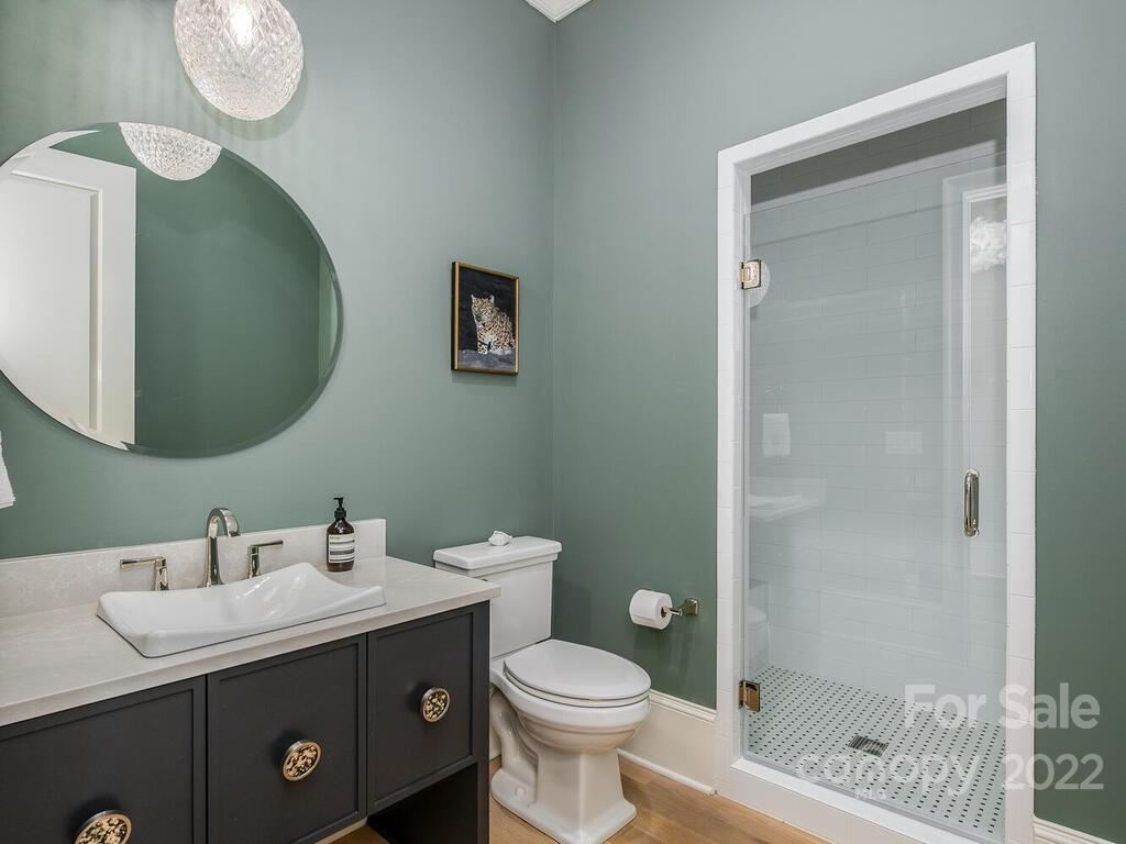 3013 Manor Road Charlotte, NC 28209 - Photo 4 of 41 a bathroom with a sink a toilet and shower