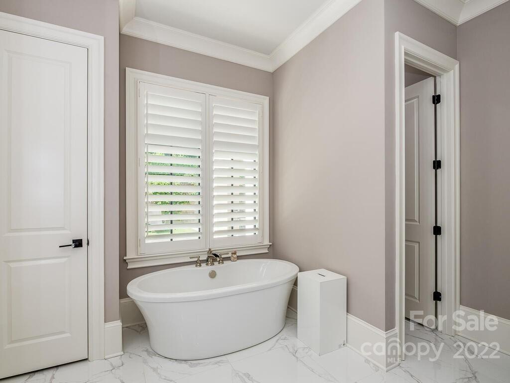 3013 Manor Road Charlotte, NC 28209 - Photo 10 of 41 a bathroom with a bathtub and shower