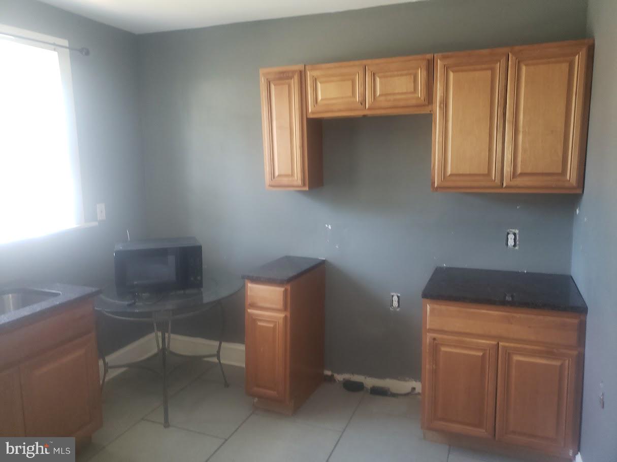 3615 Springdale Avenue Baltimore, MD 21216 - Photo 15 of 17 a room with cabinets and a window