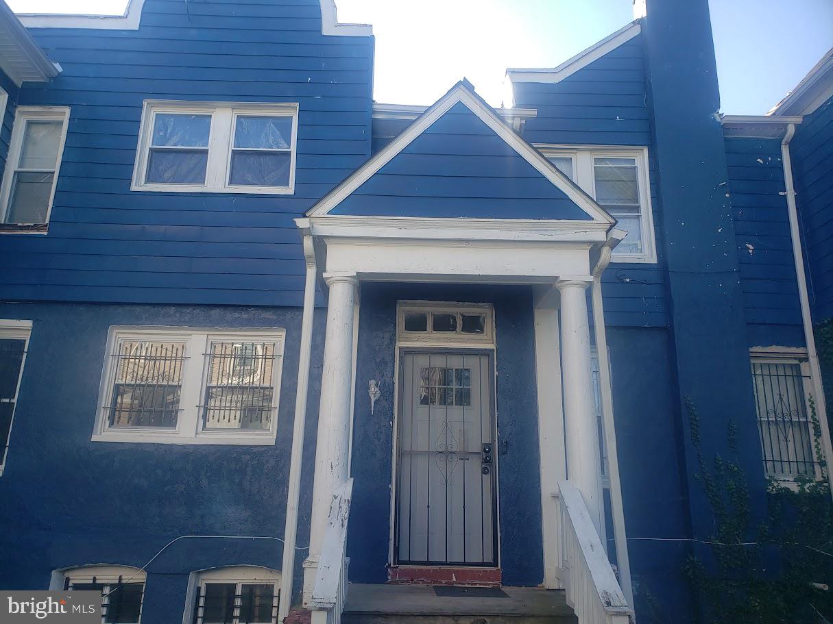 3615 Springdale Avenue Baltimore, MD 21216 - Photo 5 of 17 a front view of a house with a glass door