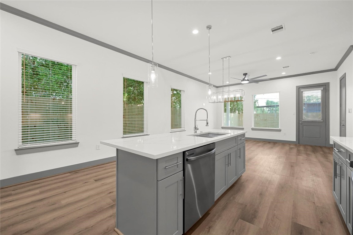 4019 Stassen Street, Unit A Houston, TX 77051 - Photo 15 of 35 a kitchen with a sink stove and wooden floor