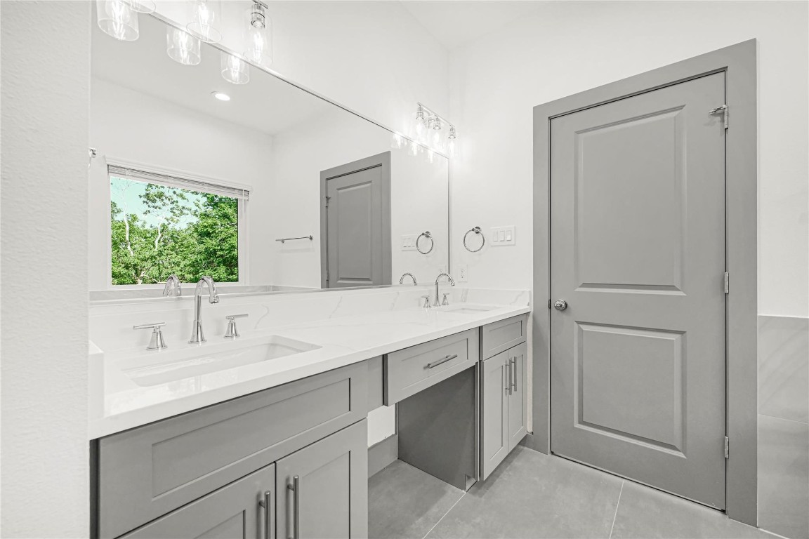 4019 Stassen Street, Unit A Houston, TX 77051 - Photo 24 of 35 a bathroom with a double vanity sink mirror and next to a window
