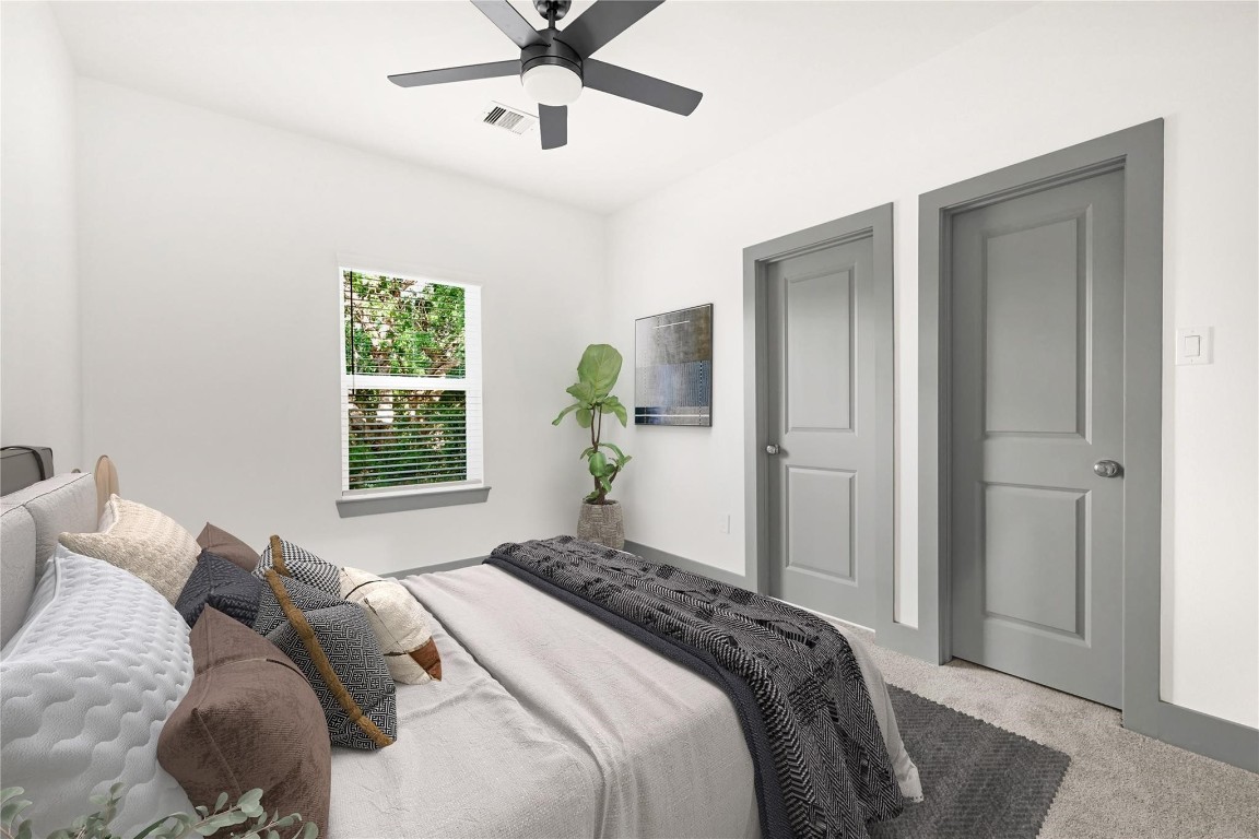 4019 Stassen Street, Unit A Houston, TX 77051 - Photo 27 of 35 a bedroom with a bed and a chandelier