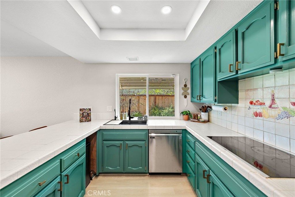 5649 Roane Drive Oceanside, CA 92057 - Photo 12 of 42 a kitchen with a sink cabinets and window