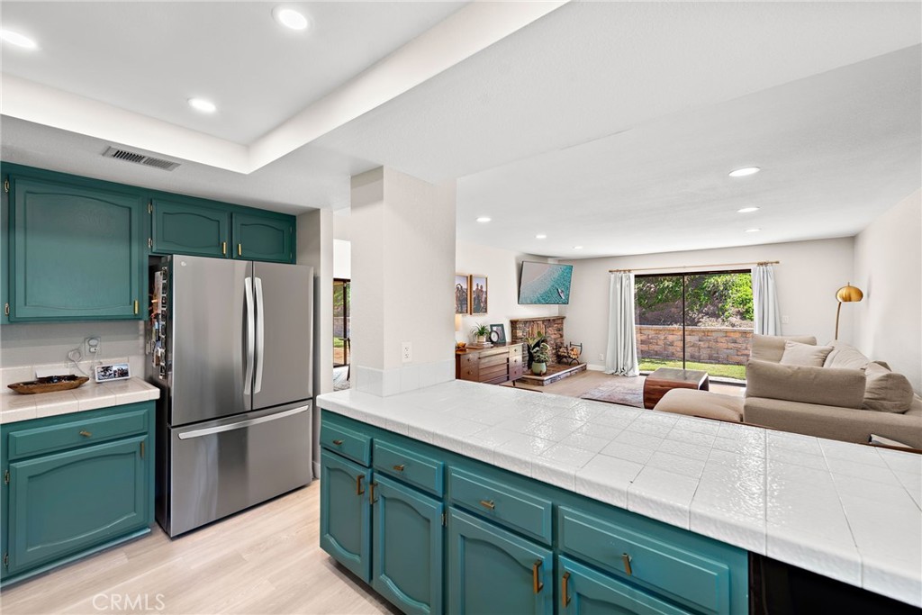 5649 Roane Drive Oceanside, CA 92057 - Photo 13 of 42 a kitchen with granite countertop a refrigerator and a sink