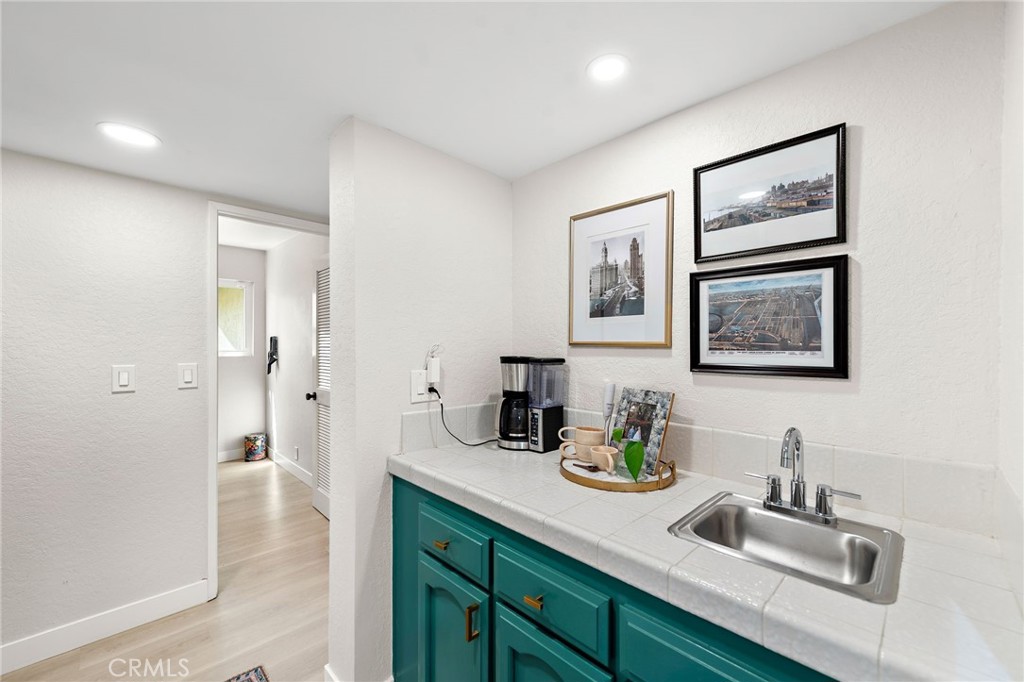 5649 Roane Drive Oceanside, CA 92057 - Photo 14 of 42 a bathroom with a double vanity sink and a mirror