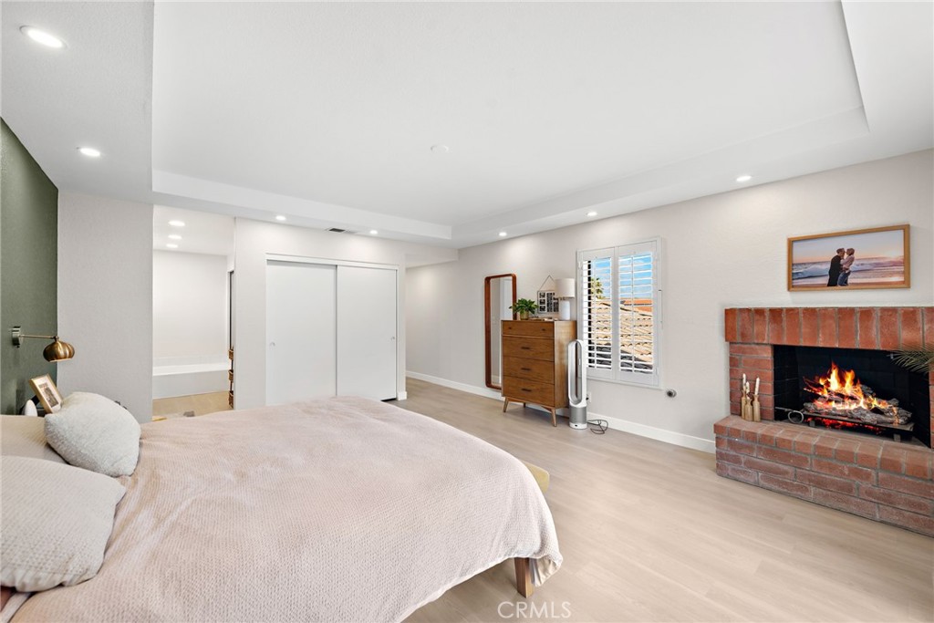 5649 Roane Drive Oceanside, CA 92057 - Photo 18 of 42 a spacious bedroom with a bed and a fireplace