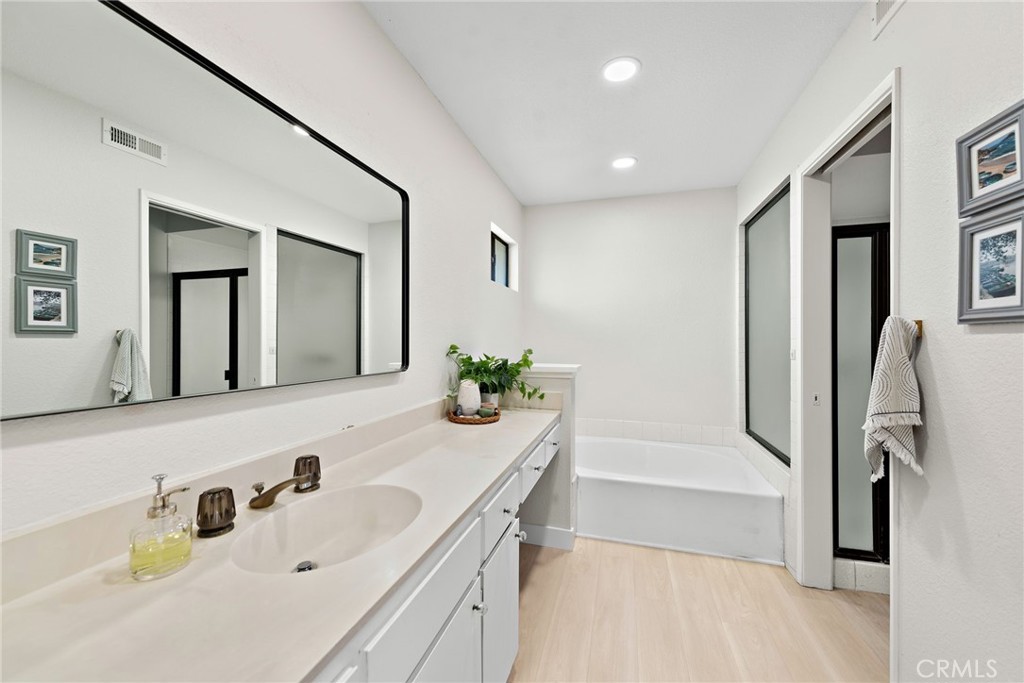 5649 Roane Drive Oceanside, CA 92057 - Photo 19 of 42 a bathroom with a tub sink and mirror