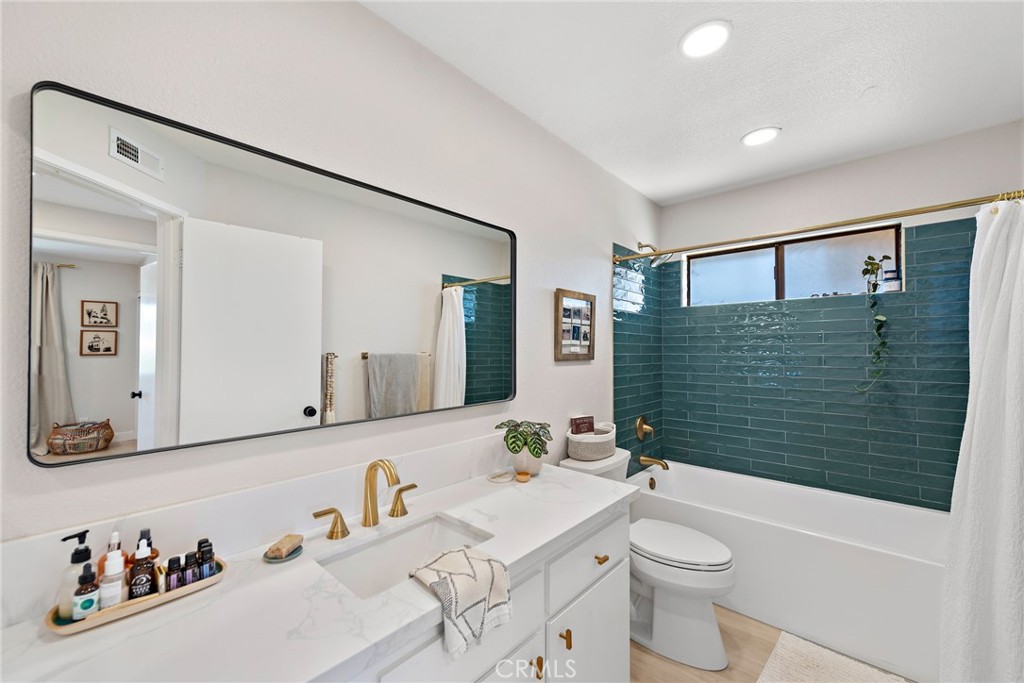 5649 Roane Drive Oceanside, CA 92057 - Photo 22 of 42 a bathroom with a sink a toilet and shower