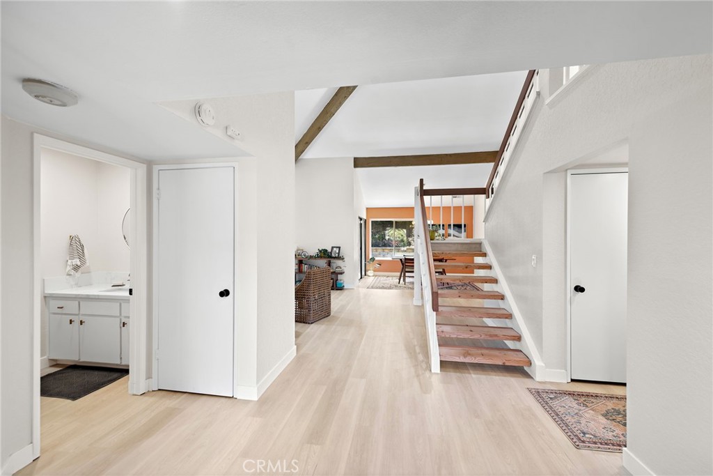 5649 Roane Drive Oceanside, CA 92057 - Photo 3 of 42 a view of a hallway with wooden floor and entryway