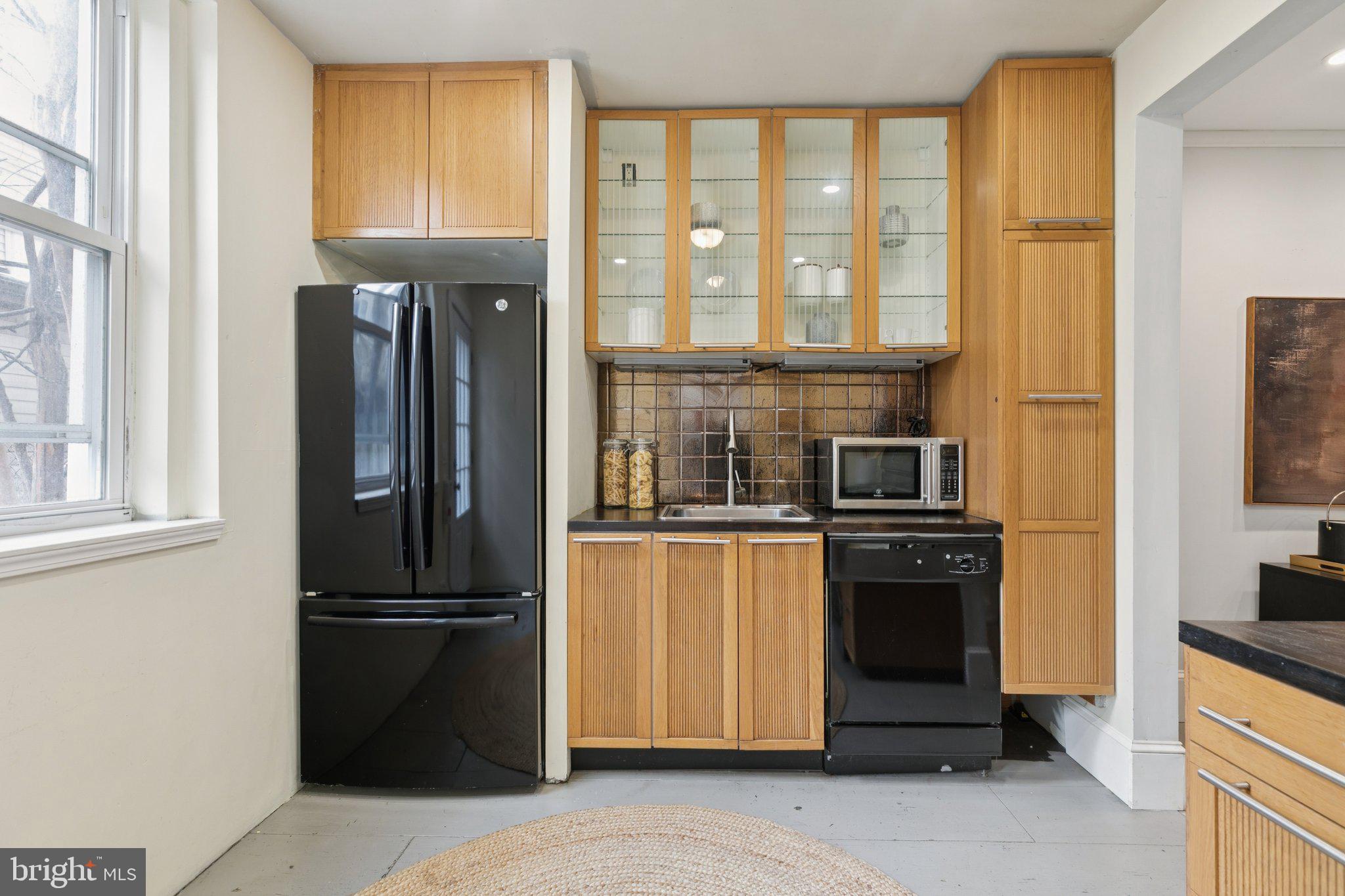 1228 Catharine Street Philadelphia, PA 19147 - Photo 15 of 48 a kitchen with stainless steel appliances granite countertop a refrigerator and a stove