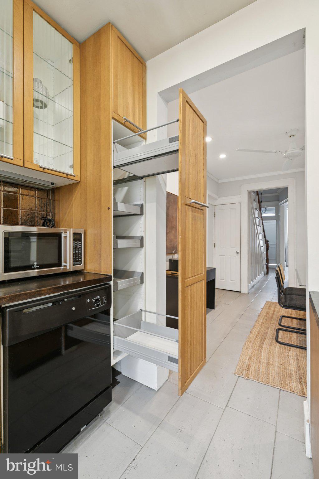 1228 Catharine Street Philadelphia, PA 19147 - Photo 18 of 48 a kitchen with stainless steel appliances kitchen island granite countertop a refrigerator and a stove