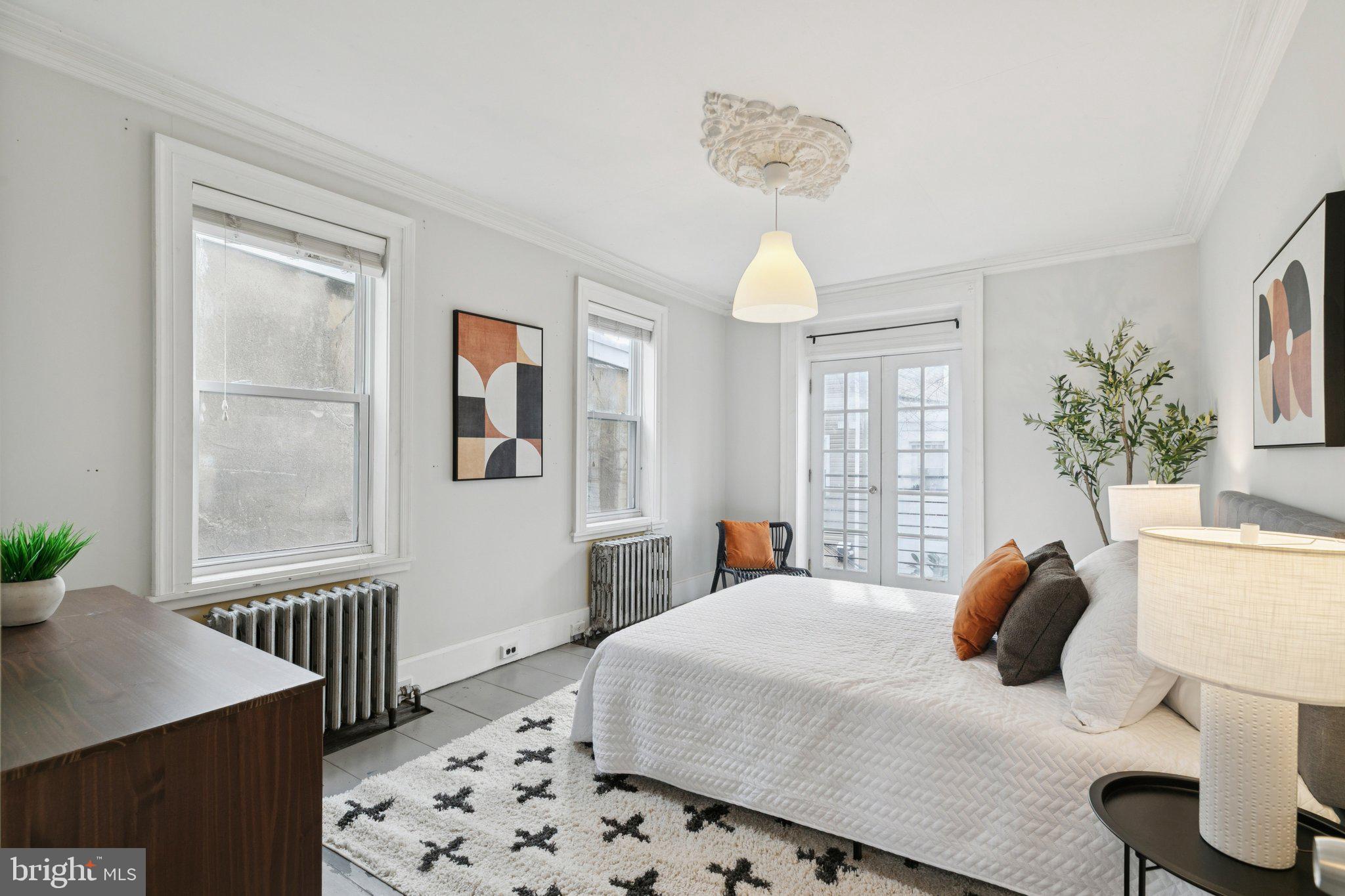 1228 Catharine Street Philadelphia, PA 19147 - Photo 22 of 48 a bedroom with a bed and window