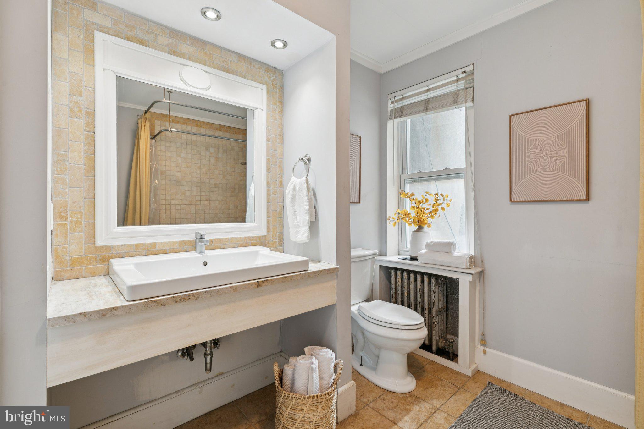 1228 Catharine Street Philadelphia, PA 19147 - Photo 26 of 48 a bathroom with a toilet sink and mirror