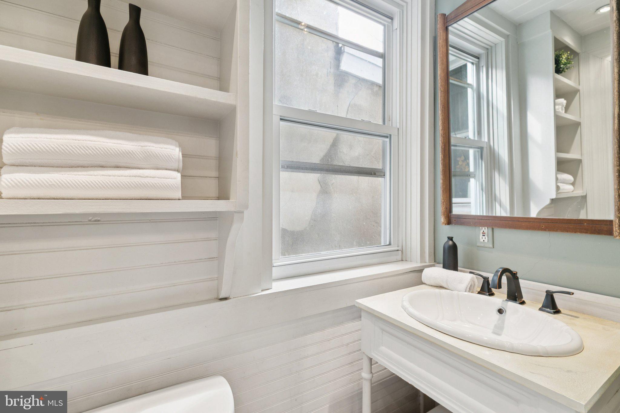 1228 Catharine Street Philadelphia, PA 19147 - Photo 32 of 48 a bathroom with a sink and a mirror