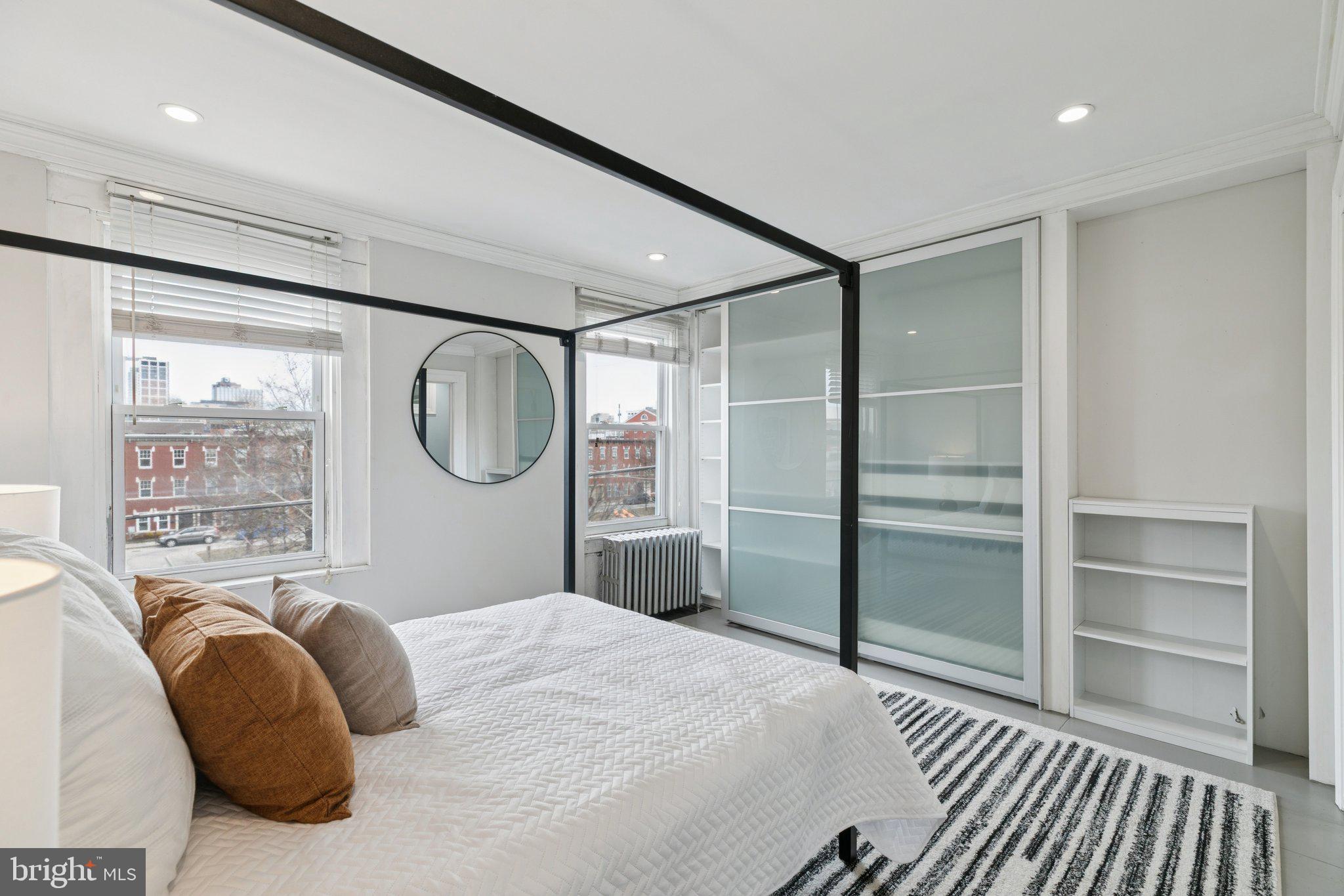 1228 Catharine Street Philadelphia, PA 19147 - Photo 38 of 48 a bedroom with a bed mirror and a window