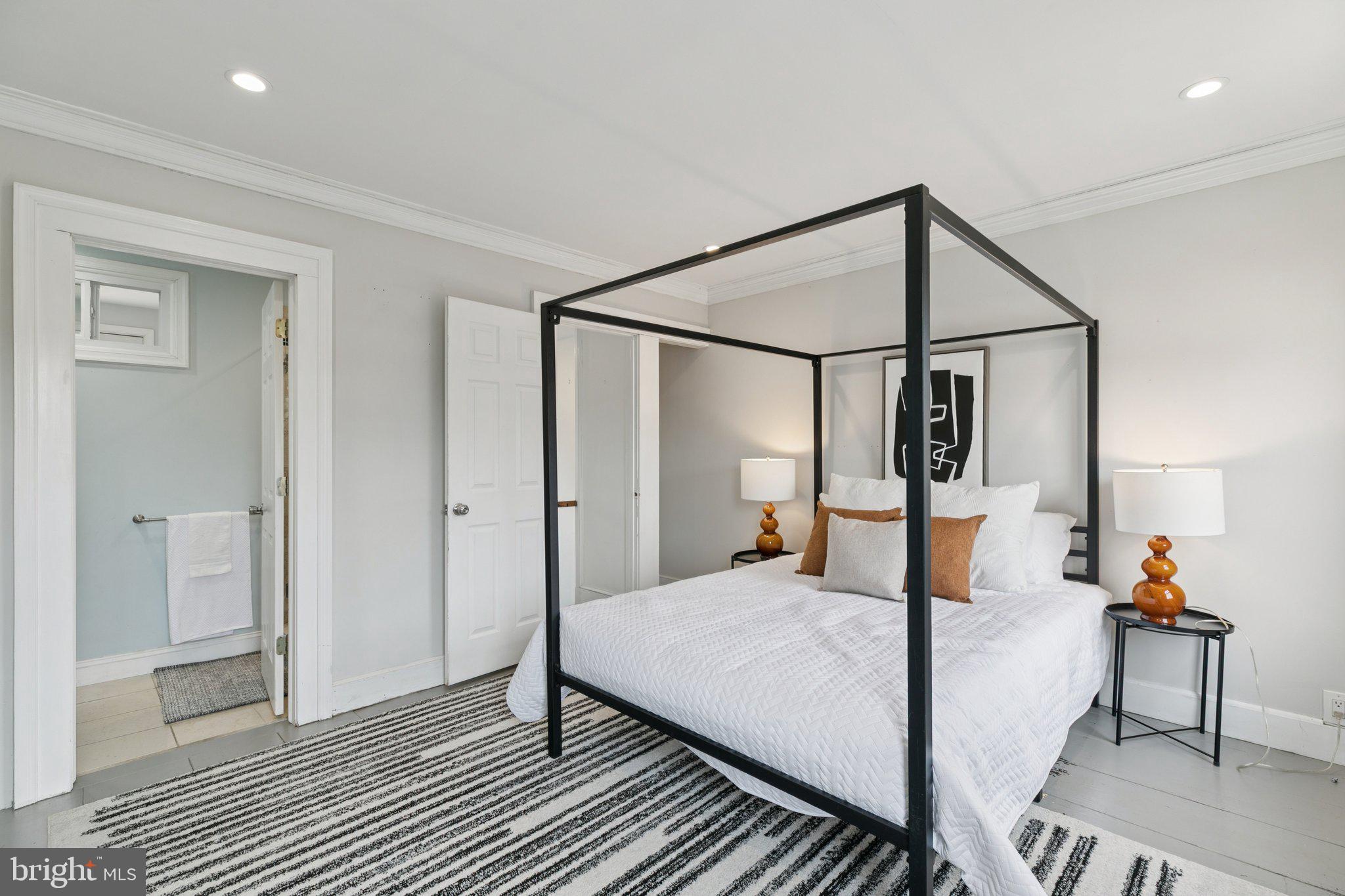 1228 Catharine Street Philadelphia, PA 19147 - Photo 41 of 48 a bedroom with a bed a mirror and a window