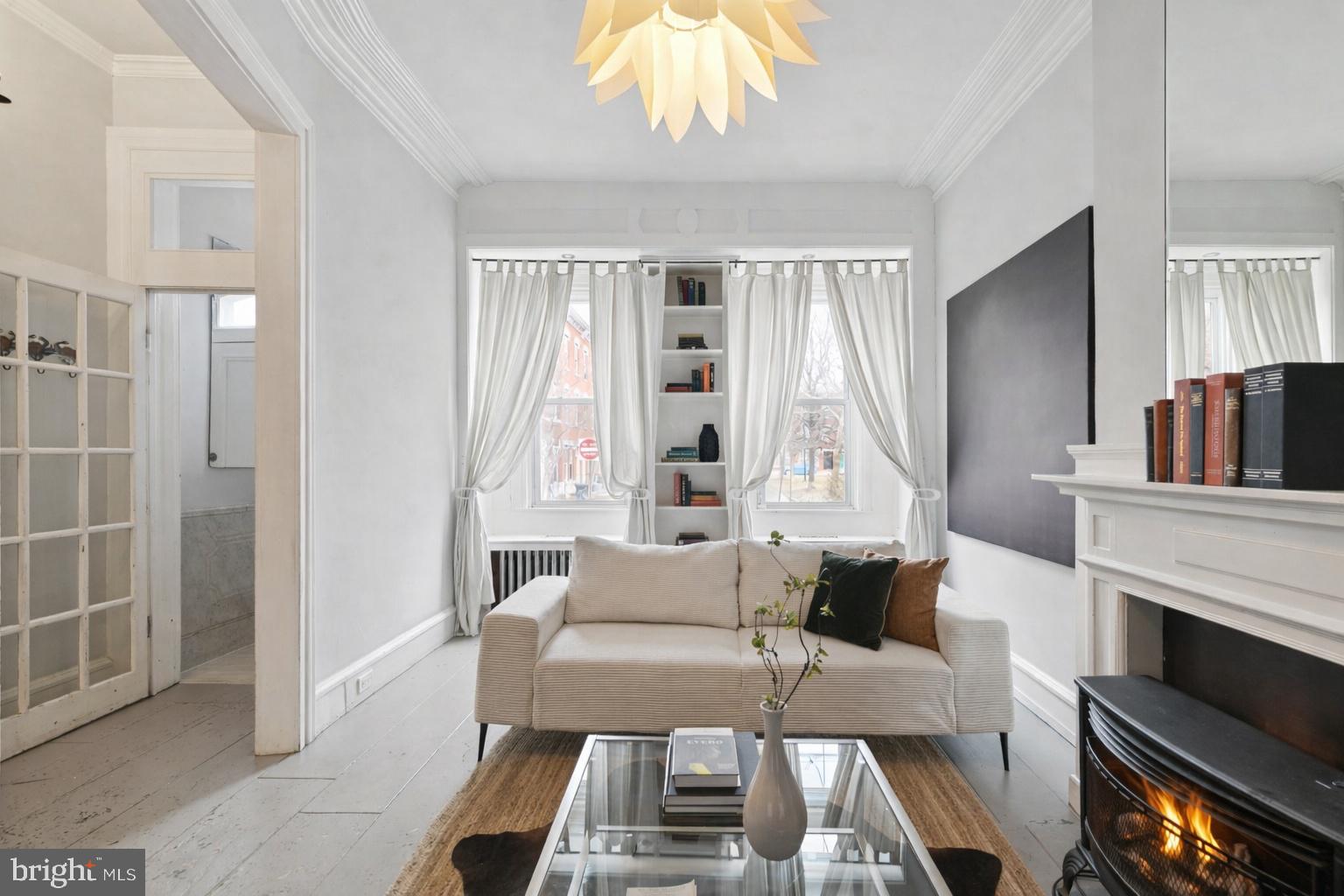 1228 Catharine Street Philadelphia, PA 19147 - Photo 5 of 48 a living room with furniture a fireplace and a chandelier