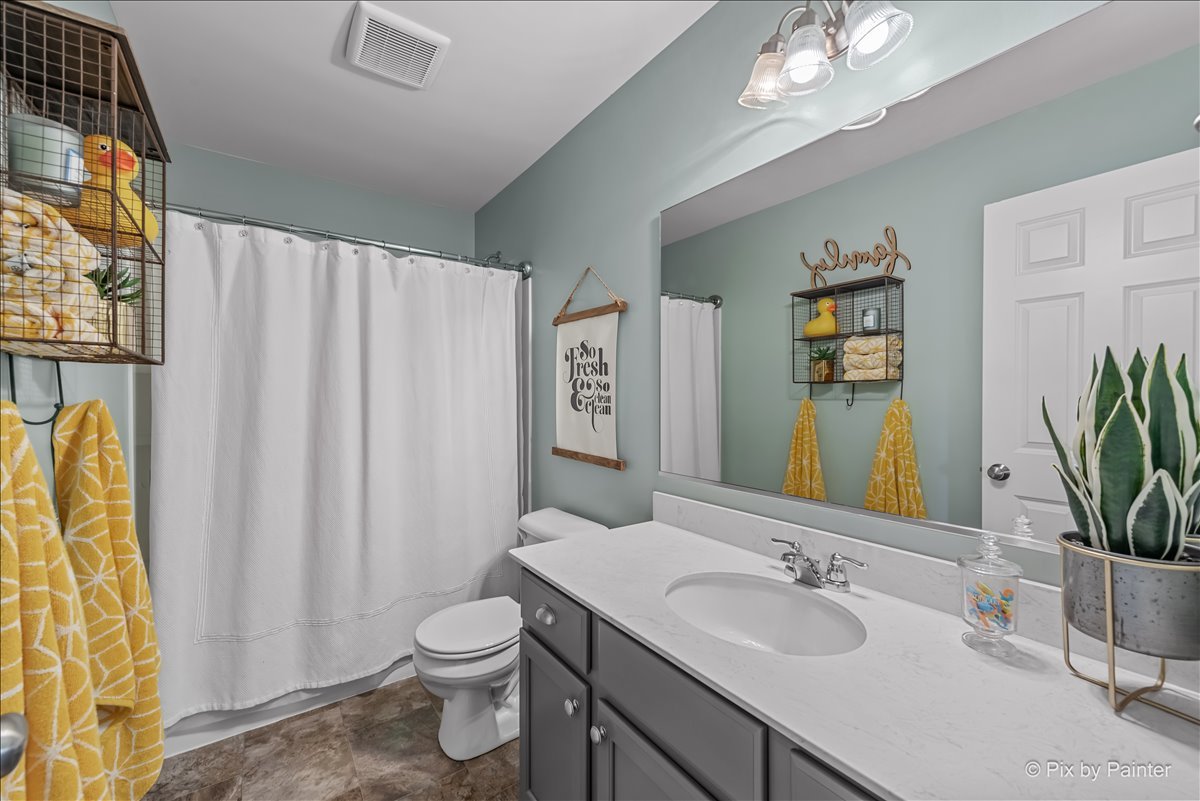 16207 West Switch Grass Road Lockport, IL 60441 - Photo 24 of 45 a bathroom with a granite countertop sink toilet and mirror