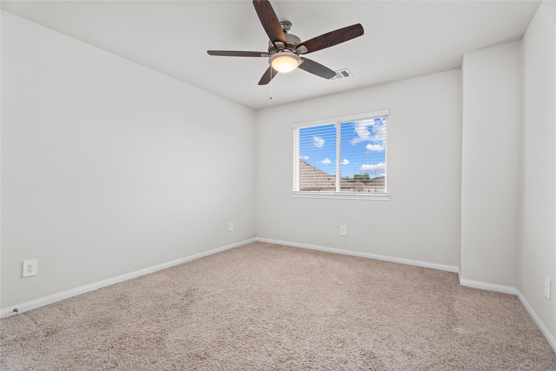 980 Rice Drive Bryan, TX 77803 - Photo 21 of 31 an empty room with a window and a ceiling fan