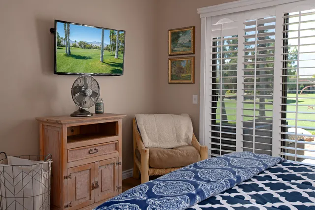 a bedroom with a bed and a television