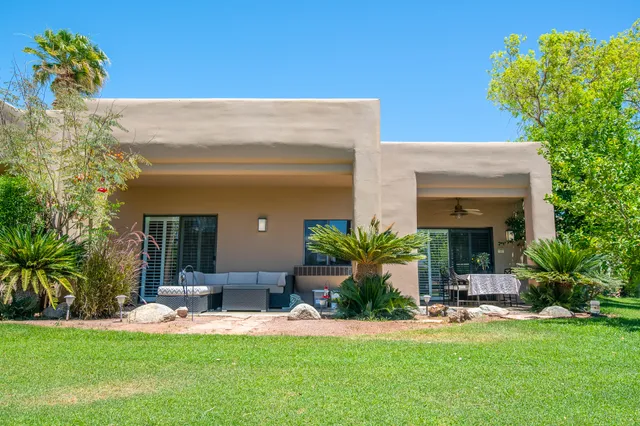 a view of a house with backyard and a garden