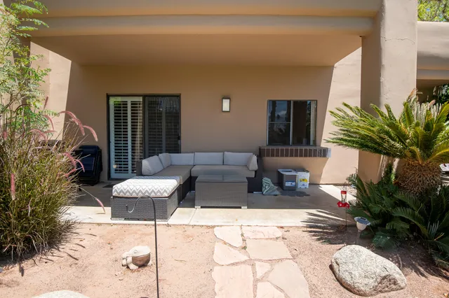 a outdoor space with patio the couch and potted plants