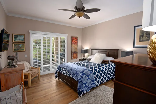 a bedroom with bed couch and window