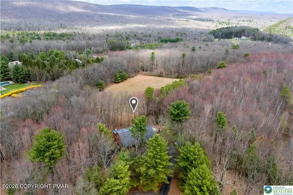 an aerial view of a house with a garden