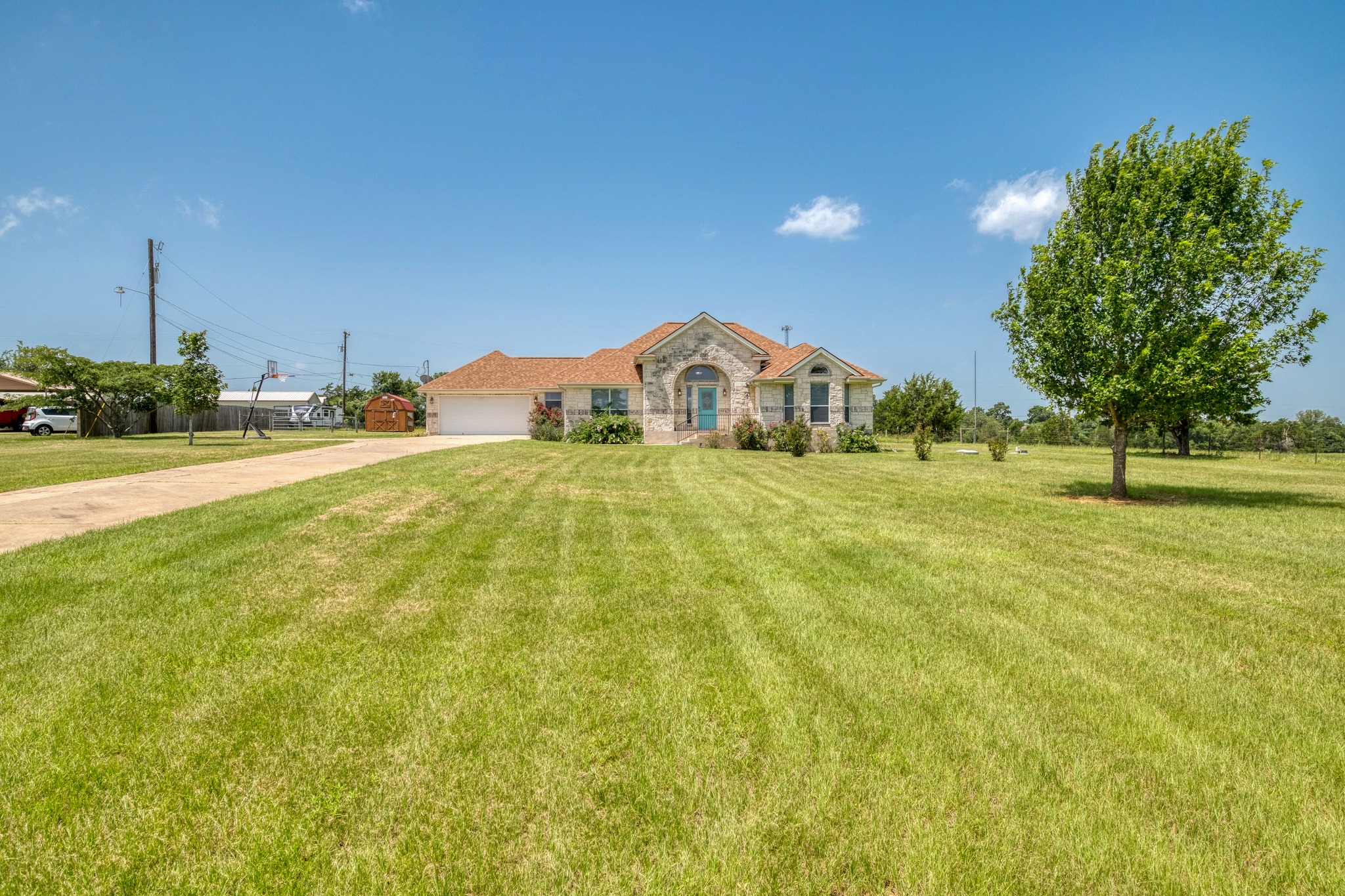 341 Brown Road McDade, TX 78650 - Photo 4 of 38 A graceful stone facade welcomes you to this spacious home with a wide driveway and ample lawn.