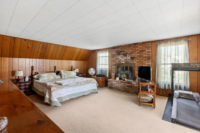 a bedroom with furniture and a fireplace