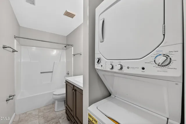 a bathroom with a toilet a sink and shower