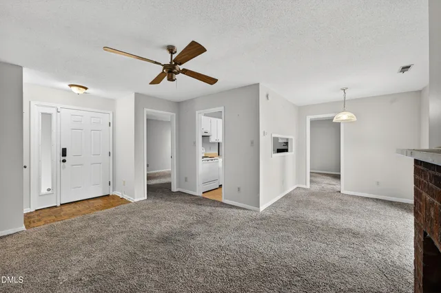 a view of empty room with ceiling fan
