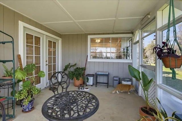 a dining room with furniture water view and a floor to ceiling window
