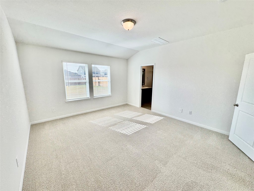 141 Boondoggle Ridge Cedar Creek, TX 78612 - Photo 3 of 7 Unfurnished bedroom featuring carpet flooring and lofted ceiling