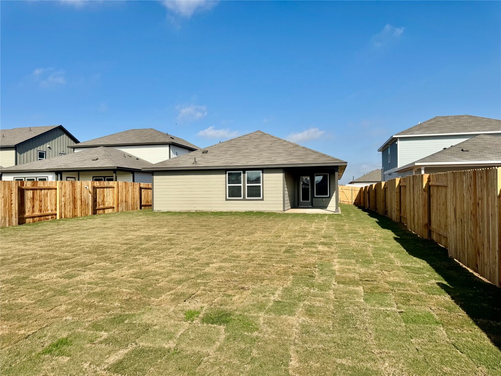 141 Boondoggle Ridge Cedar Creek, TX 78612 - Photo 5 of 7 Back of property featuring a patio and a fenced backyard