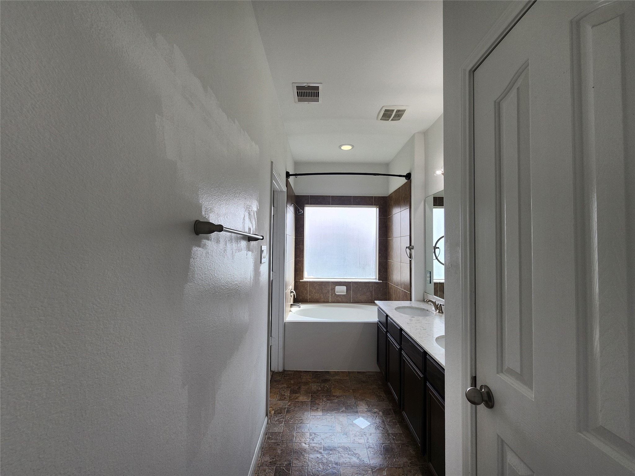 9346 Valley Tree Lane Houston, TX 77089 - Photo 11 of 21 a bathroom with a double vanity sink a mirror and a bathtub