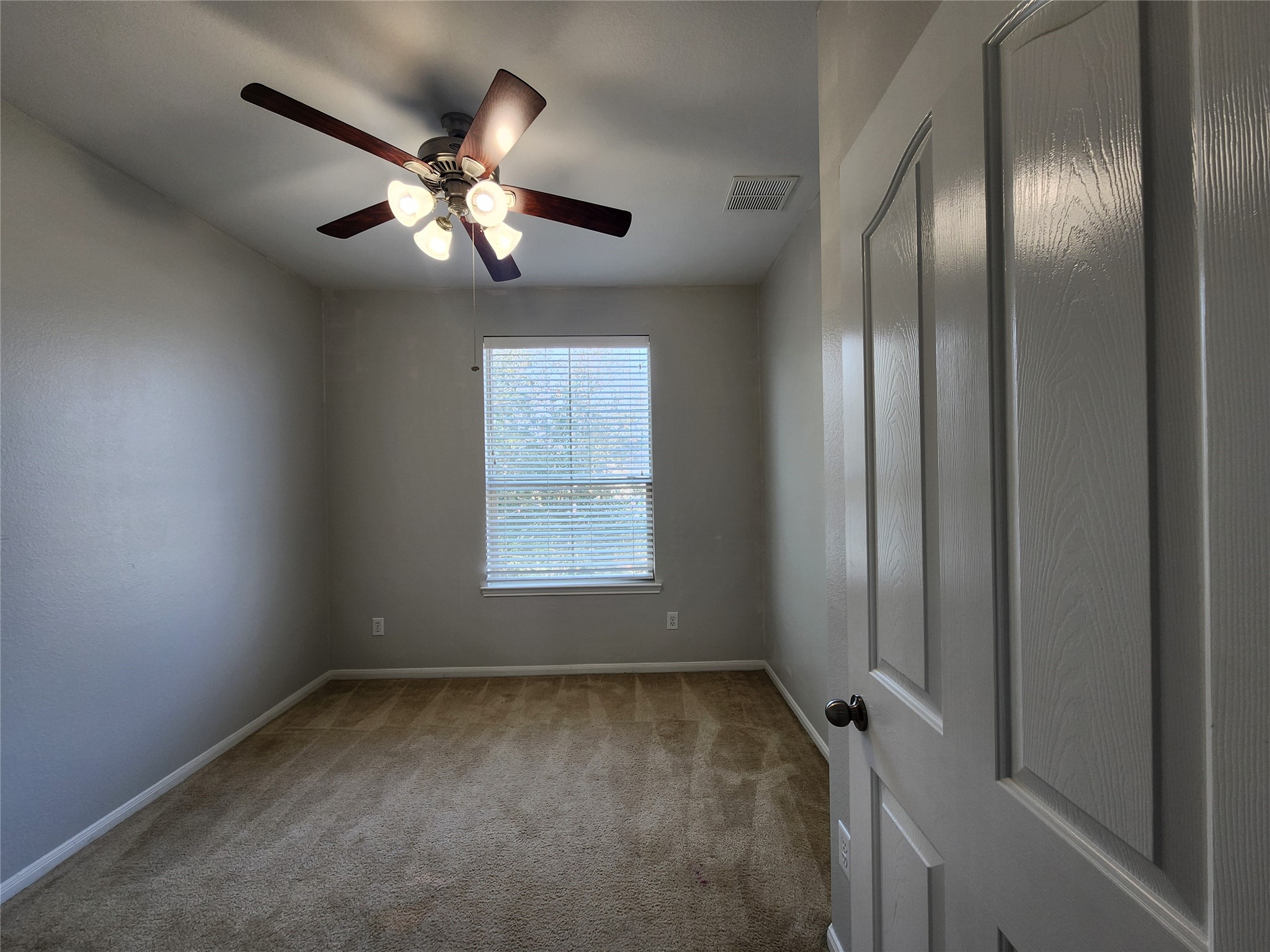 9346 Valley Tree Lane Houston, TX 77089 - Photo 16 of 21 an empty room with windows and fan