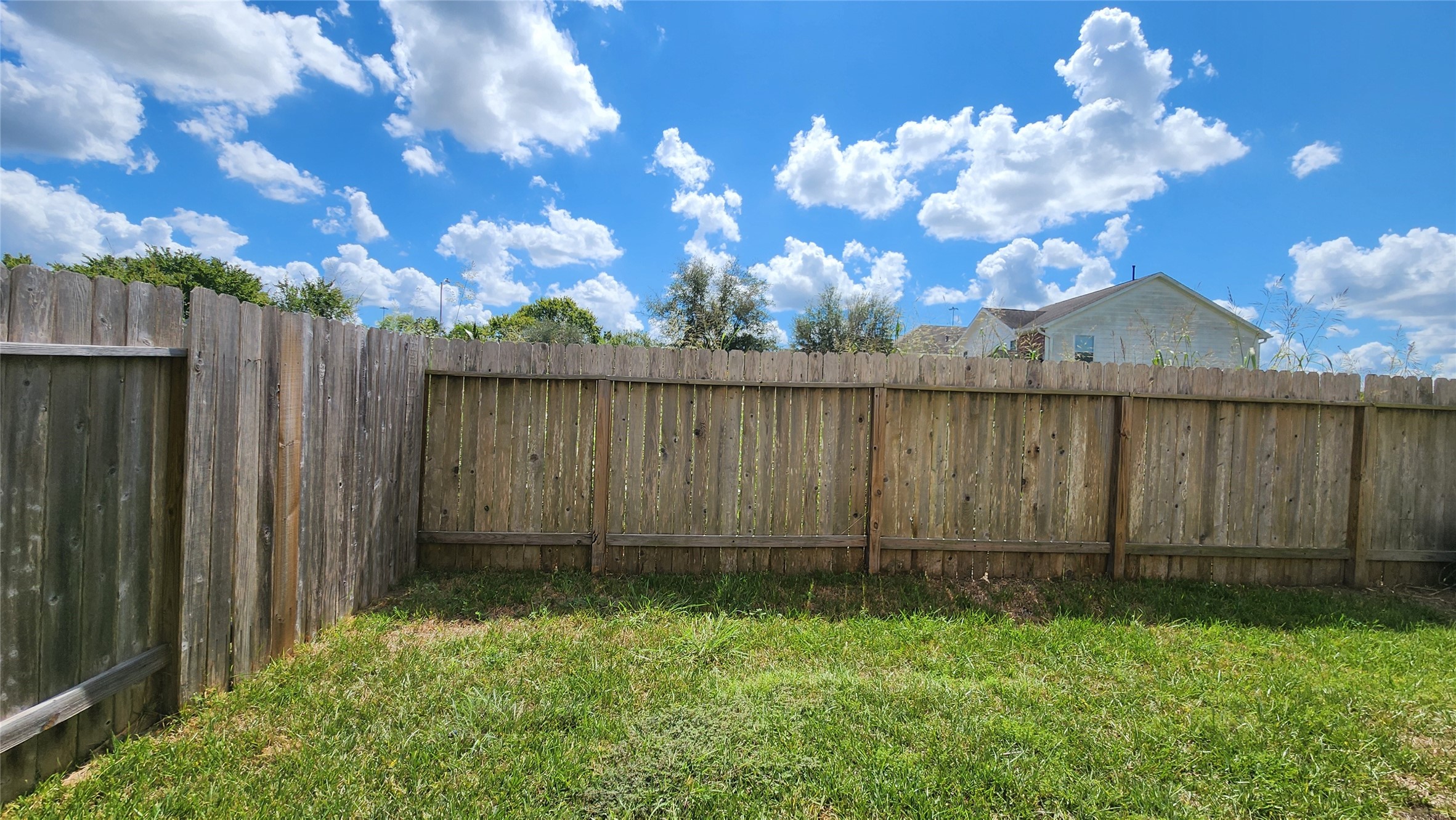 9346 Valley Tree Lane Houston, TX 77089 - Photo 20 of 21 a view of a backyard with potted plants and wooden fence
