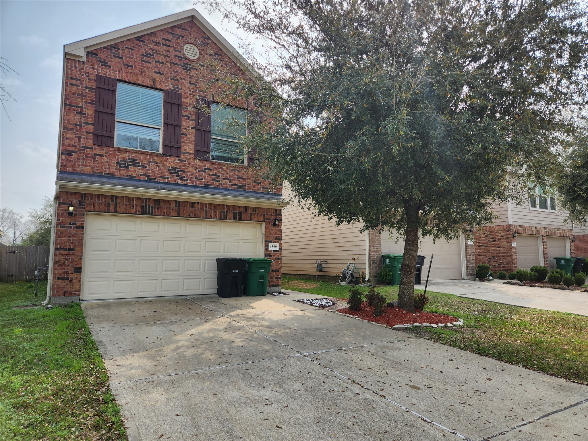 9346 Valley Tree Lane Houston, TX 77089 - Photo 2 of 21 a front view of a house with a yard and garage