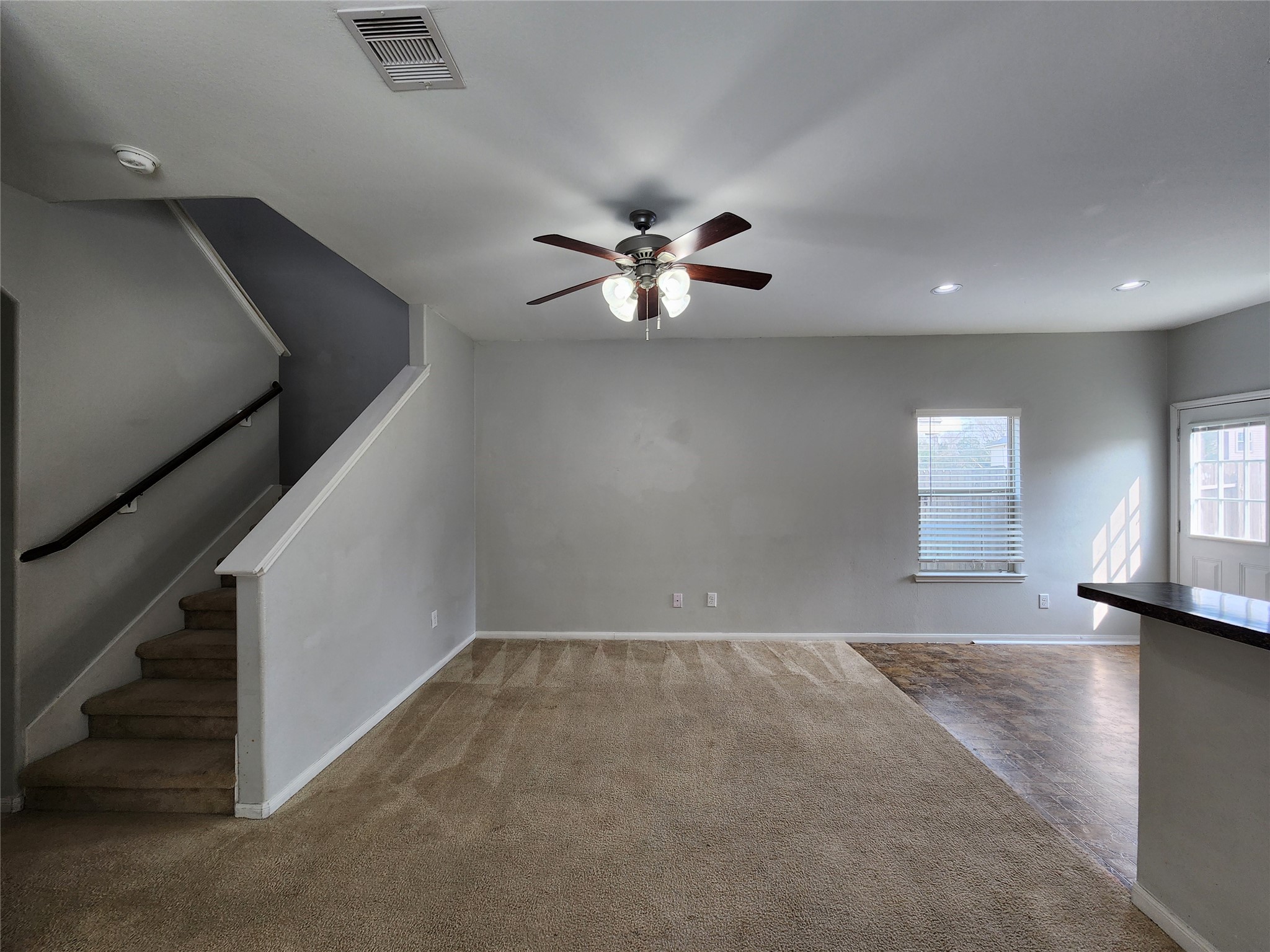 9346 Valley Tree Lane Houston, TX 77089 - Photo 6 of 21 an empty room with windows and fan