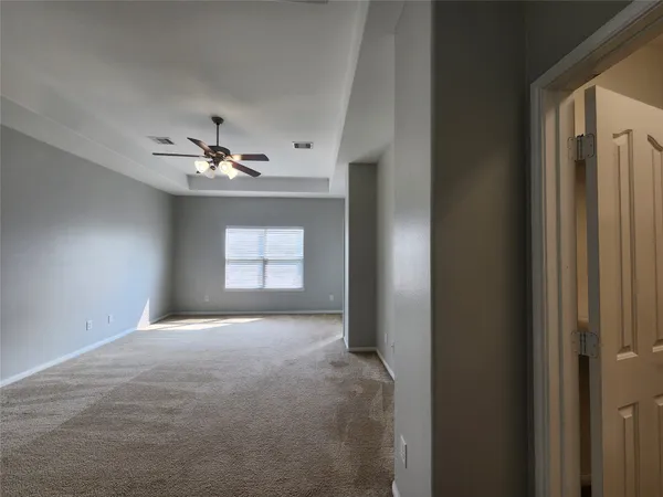 a view of an empty room with chandelier