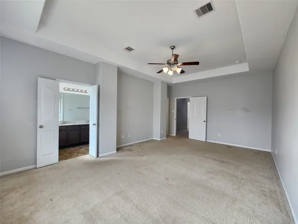 a view of an empty room with a ceiling fan