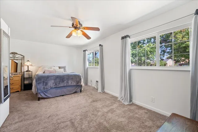 a bedroom with a bed and window