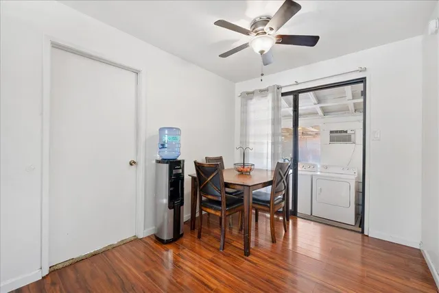 a view of a dining room with furniture and wooden floor